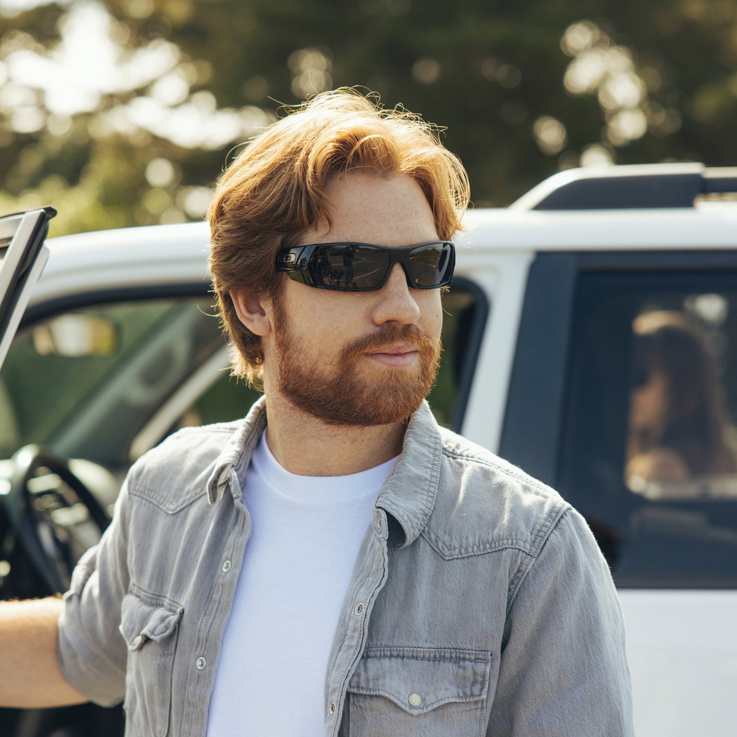 a person wearing sunglasses with stealth black lenses